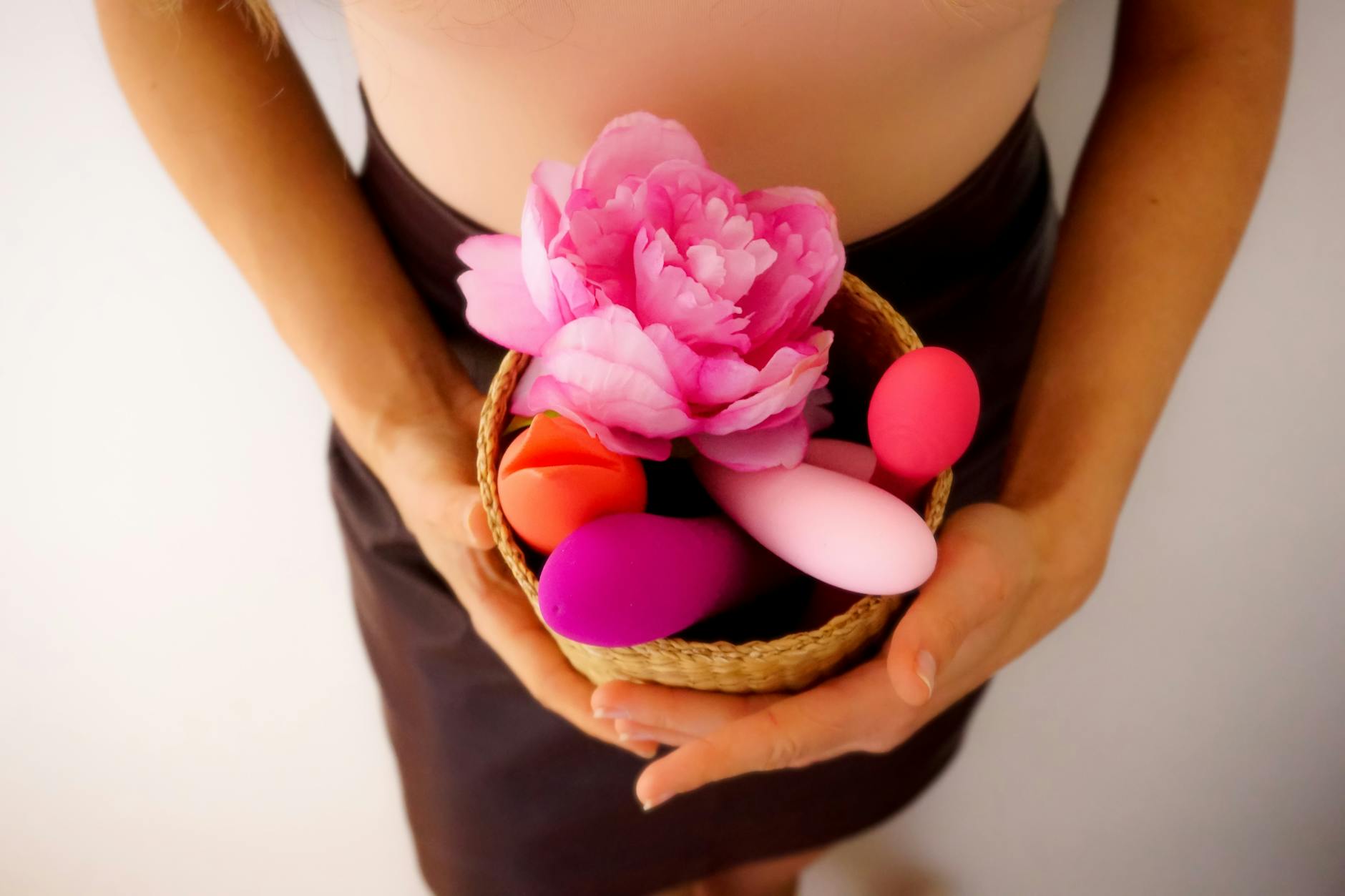 Pink vibrator on a purple background with romantic candlelight and heart confetti