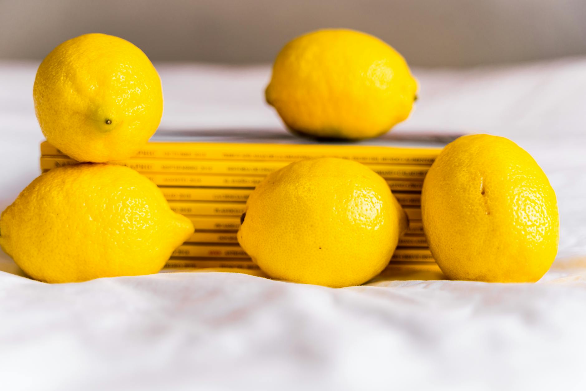 Fresh lemons on a white surface, symbolizing the clarity you need when stress derails pleasure